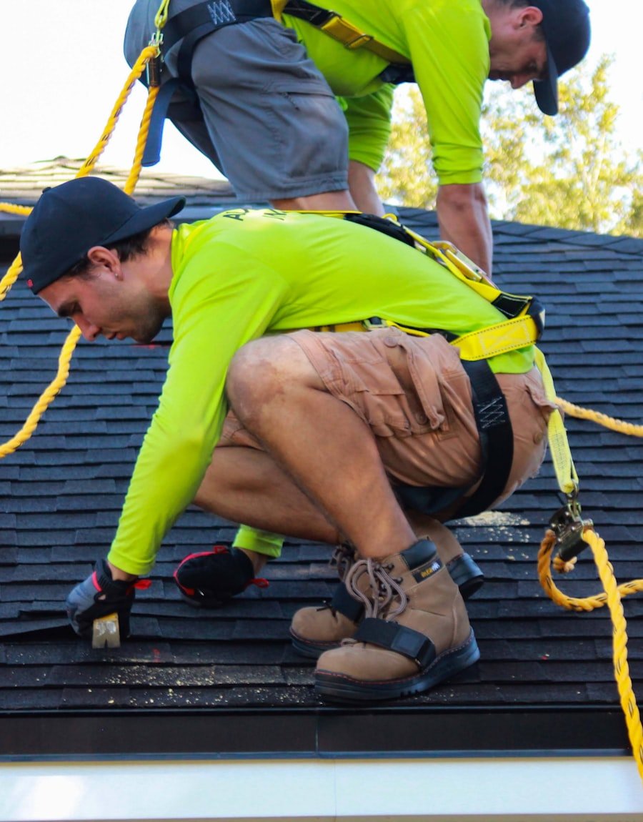 MRB Exteriors roofing crew installing shingles with fall-protection harnesses